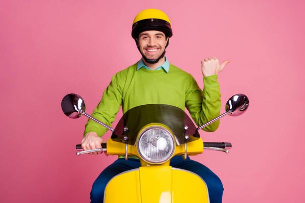 Portrait of his he nice attractive confident cheerful cheery guy riding moped showing advert ad new novelty like follow subscribe solution isolated over pink pastel color background - Фото, зображення