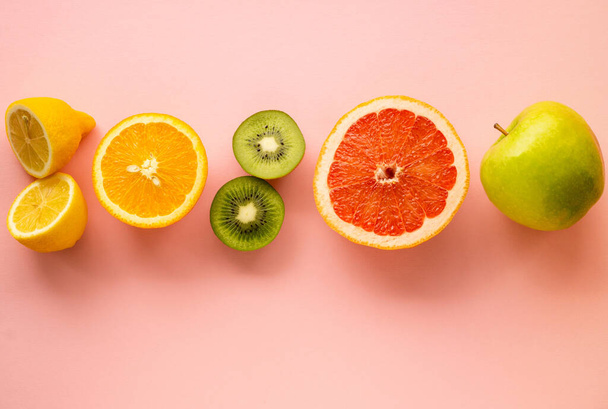 Fruits containing vitamin c on a colored background - Photo, Image