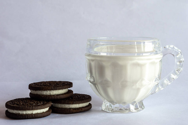A cup of healthy milk and some sweet cookies. - Photo, Image