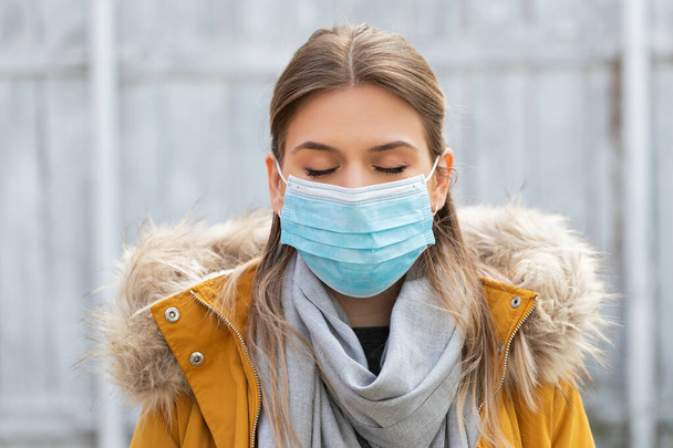 Portrait of young woman wearing protective mask - coronavirus pandemic alert - Fotó, kép