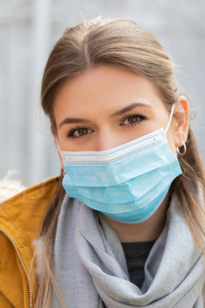 Portrait of young woman wearing protective mask - coronavirus pandemic alert - Fotó, kép