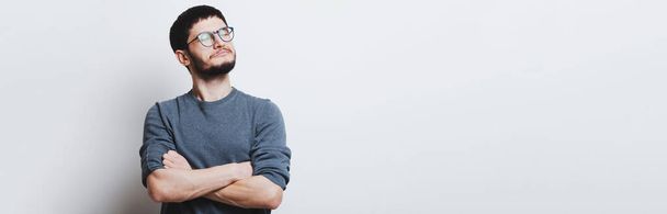 Panoramic banner, portrait of young confident guy with crossed arms wearing eyeglasses on white background with copy space. - Photo, Image