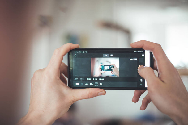 Close up of black smartphone camera, filming and making pictures indoors. Content production. - Fotoğraf, Görsel