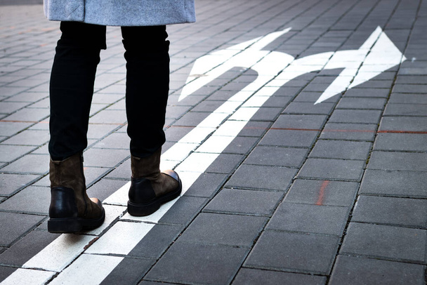 Make choice which way to go. Decision concept with directional arrow sign on road and woman - Foto, Imagem