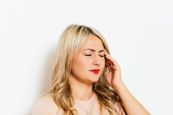 Headache woman against studio background - Valokuva, kuva