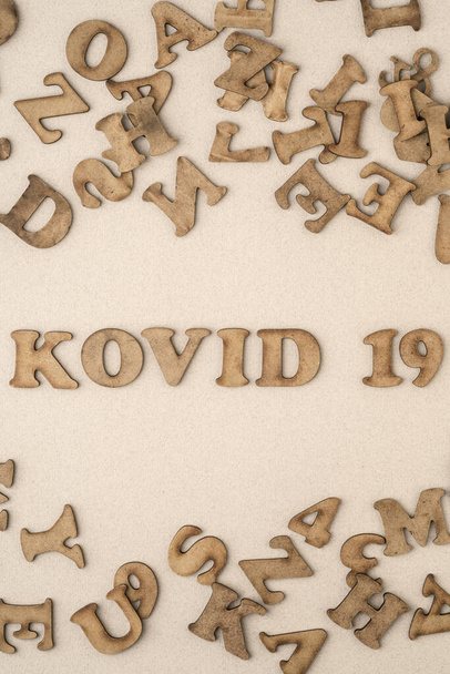 Epidemic corona virus covid 19 written with carved wooden letters in Turkish. Kovid means covid in Turkish. - Photo, Image