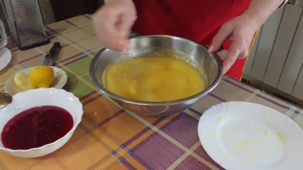 Simple food, pie making. A woman is stirring ingredients for a homemade pie in a bowl with a spoon. Close up. Recipe. Zooming. Siberia. - Filmagem, Vídeo