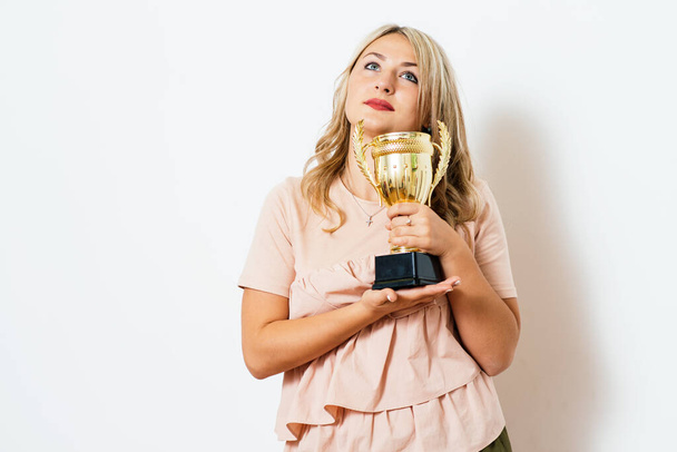 Woman with a golden cup - Фото, зображення