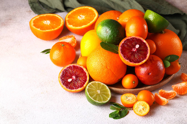 natural organic citrus fruit on a wooden plate - Photo, image