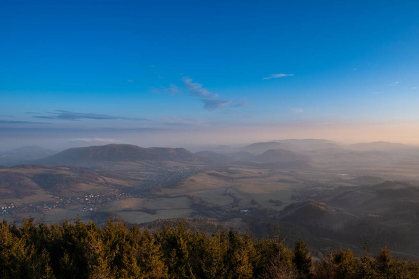 krasna czech landscape in mountains at sunrise with fog in valley at the turn of winter and spring, czech Beskydy - Photo, image