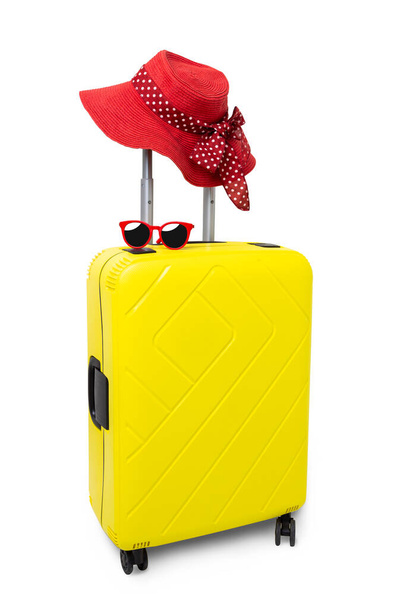 Travel Yellow Suitcase with sunglasses and red hat isolated on white background.with clipping path - 写真・画像