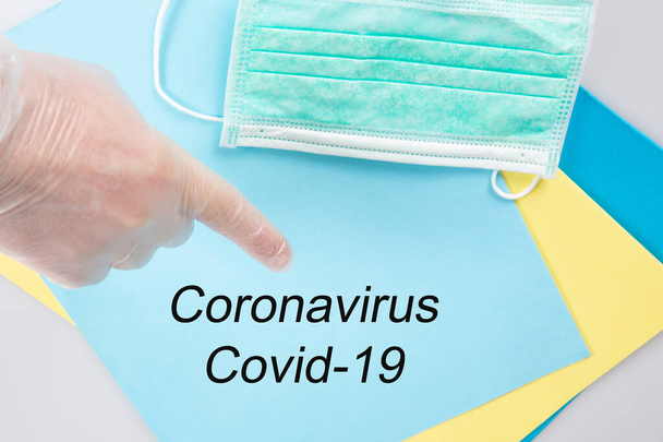 covid-19 coronavirus text disease 2019-nCoV written on blue folder man glove pointing hand doctor - Photo, Image