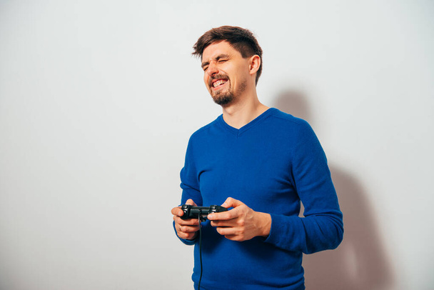 Man playing on the joystick in a game console - Fotoğraf, Görsel