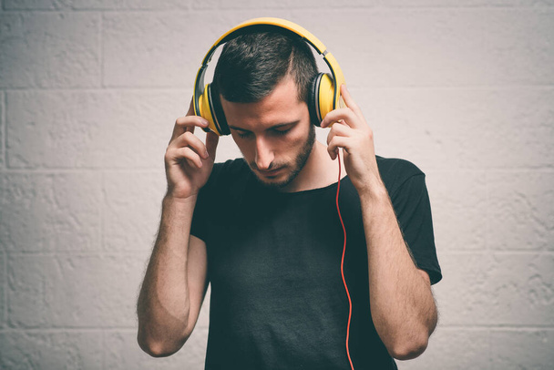 Man with headphones against studio background - Foto, imagen