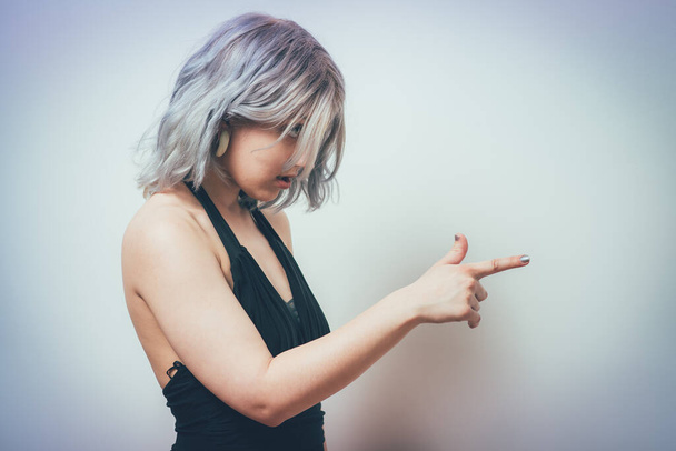 girl points to someone the finger - 写真・画像