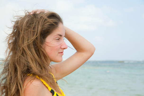 Long-haired girl against ocean - Фото, зображення