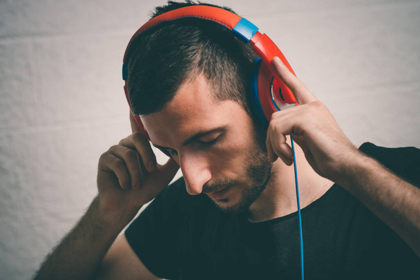 Man with headphones against studio background - Valokuva, kuva