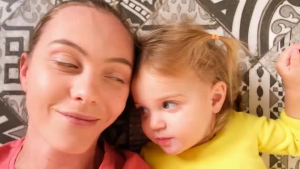 Mother and daughter enjoying each other while chilling at home - Footage, Video