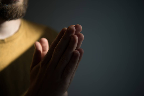 Prayer. Man. against studio background - Фото, изображение