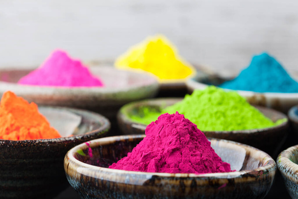 Colorful Holi powder in cups closeup. Shallow depth of field - Фото, изображение