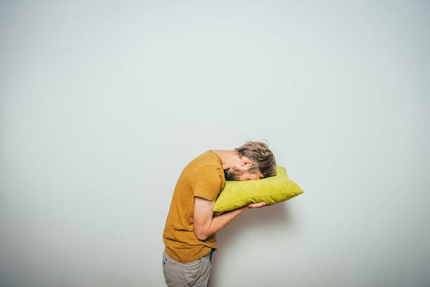 Sleep. Man against studio background - Valokuva, kuva