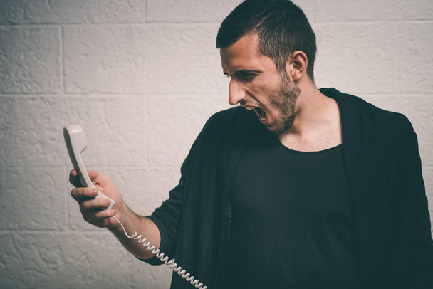 Close up image of a man screaming on the telephone during the conversation. - Foto, Imagen