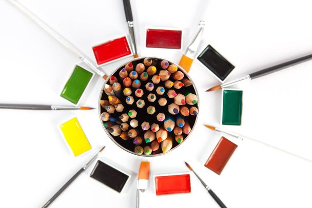 Various colorful art supplies - top view on white background with focus on foreground - Foto, afbeelding