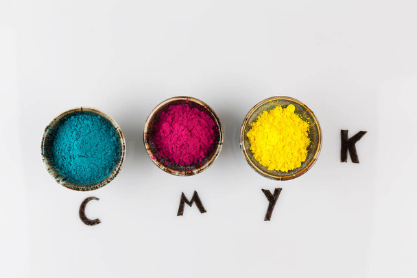 CMYK color scheme concept depicted with colorful dyed powder on whiteboard with copy space - Fotoğraf, Görsel