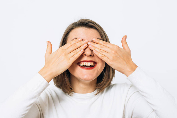 woman closes eyes with her hands - Valokuva, kuva