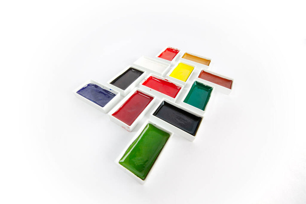 Rectangle colorful watercolor pans in creative arrangement on white background - wide angle lens distortion - Photo, image