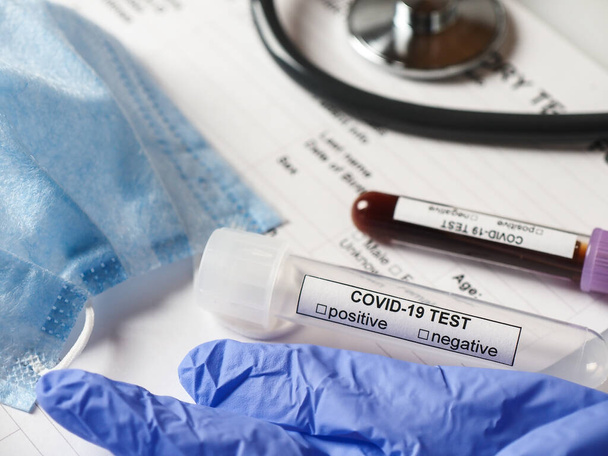 Coronavirus COVID-2019 test concept with blood test tubes, test form and other medical objects - Valokuva, kuva