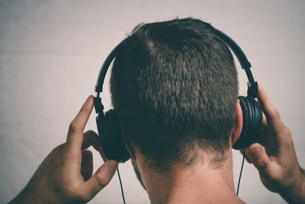 Man with headphones against studio background - 写真・画像