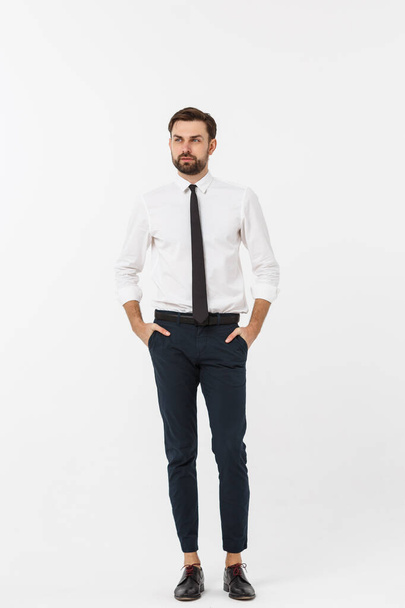 Portrait of a confident young businessman with hands in pockets on white background - Φωτογραφία, εικόνα