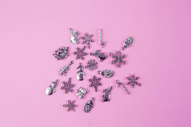 Silver Christmas decorations on pink background - top view with copy space - Photo, image