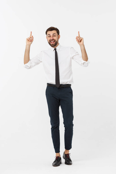 full length of young businessman shouting with winning expression loudly with his arms widened. - Photo, Image