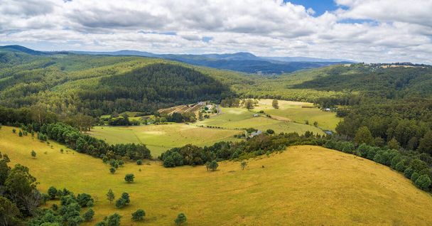 Aerial panorama of beautiful countryside with pastures and forested hills - Fotó, kép