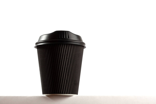 Black disposable coffee cup with copy space - close-up hero look - Fotoğraf, Görsel