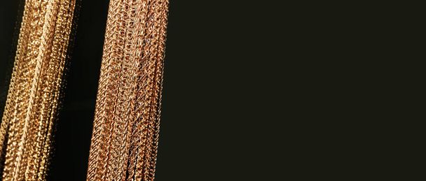 Golden chains on dark background. Luxury concept. - Photo, Image