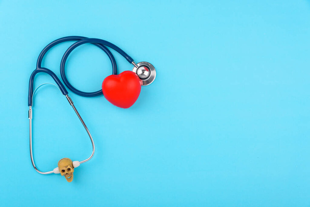 Doctor's Day concept, flat lay top view, stethoscope with red hearts diagnosis of heart disease on blue background with copy space for text - 写真・画像