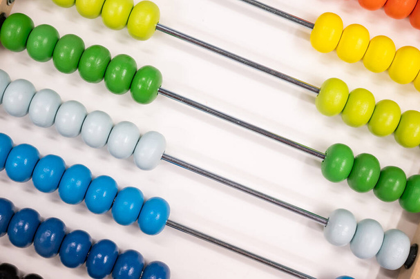 Bright colored hand abacus. Childrens wooden toy for the study of arithmetic. - Foto, imagen