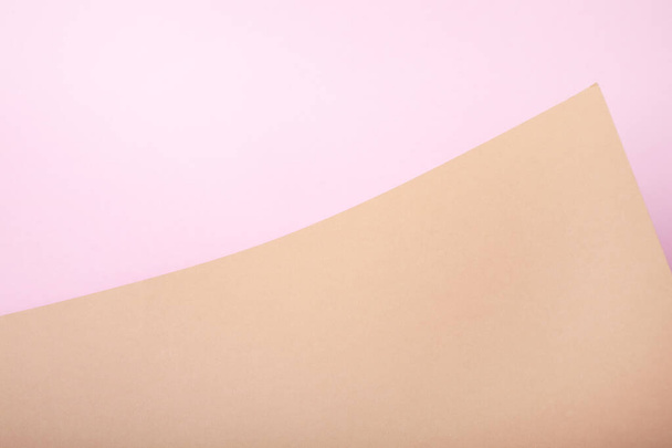 Pink and brown abstract paper background from a curved sheet. Blank for website, advertising, presentation - Φωτογραφία, εικόνα
