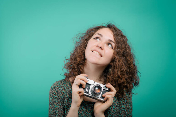 Woman with camera against studio background - Foto, Imagen
