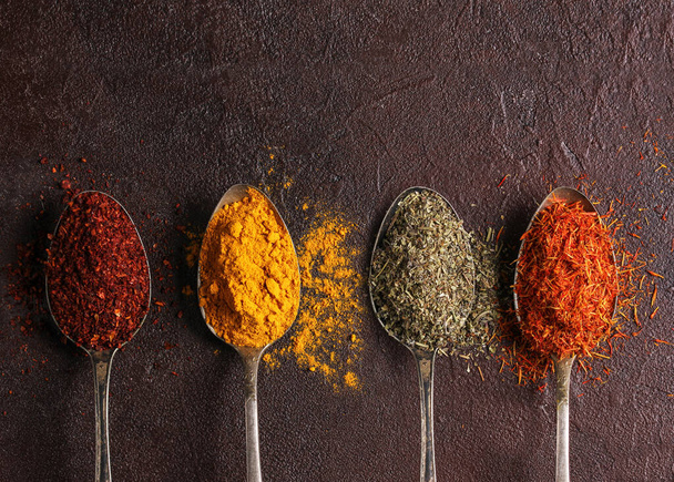 The concept of food photography. Ingredients. Spices on a dark background. Copy space, background image - Фото, изображение