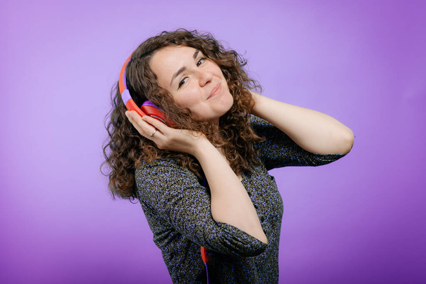 Woman with headphones against studio background - Φωτογραφία, εικόνα
