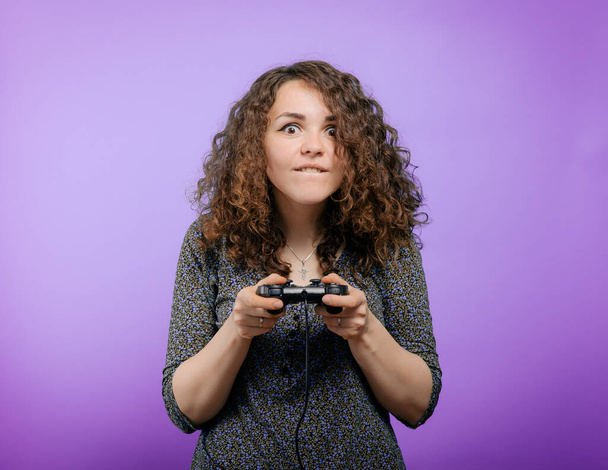 Woman playing on the joystick in a game console - Foto, Bild