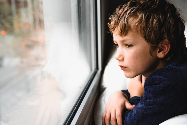 Boy stays home bored by school closings due to covid pandemic. - Zdjęcie, obraz