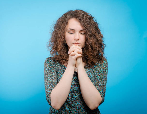 Prayer. Female. against studio background - Zdjęcie, obraz
