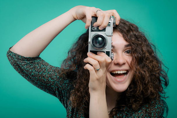 Woman with camera against studio background - Fotoğraf, Görsel