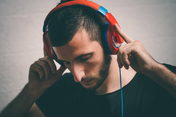 Man with headphones against studio background - Φωτογραφία, εικόνα