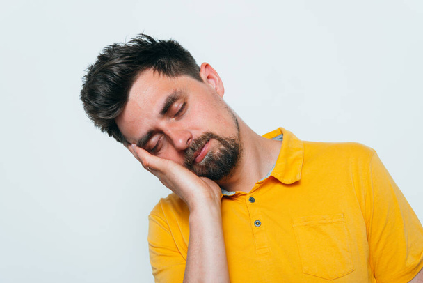 Sleep. Man against studio background  - Foto, afbeelding